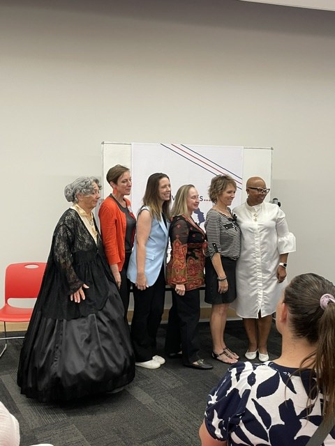 Elizabeth Sparks-Holmes with the Missouri House candidates and a suffragist reenactor in period dress at the Voices of American HERstory event on August 26, 2026