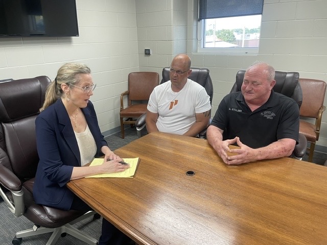 Elizabeth Sparks-Holmes taking notes while meeting with Sheriff Gary Stolzer and Major Jason Schott during her oversight visit to the Ste. Genevieve County Jail.